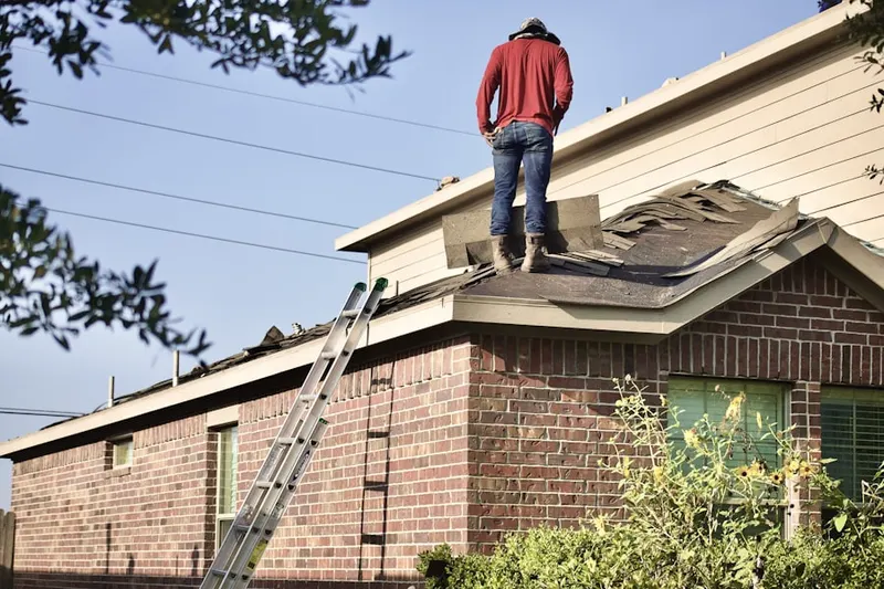 Professional roofer working on a residential roof in Longstreet